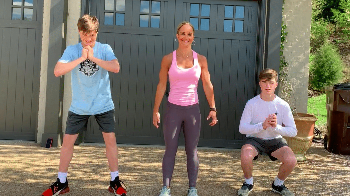Woman and two boys working out.